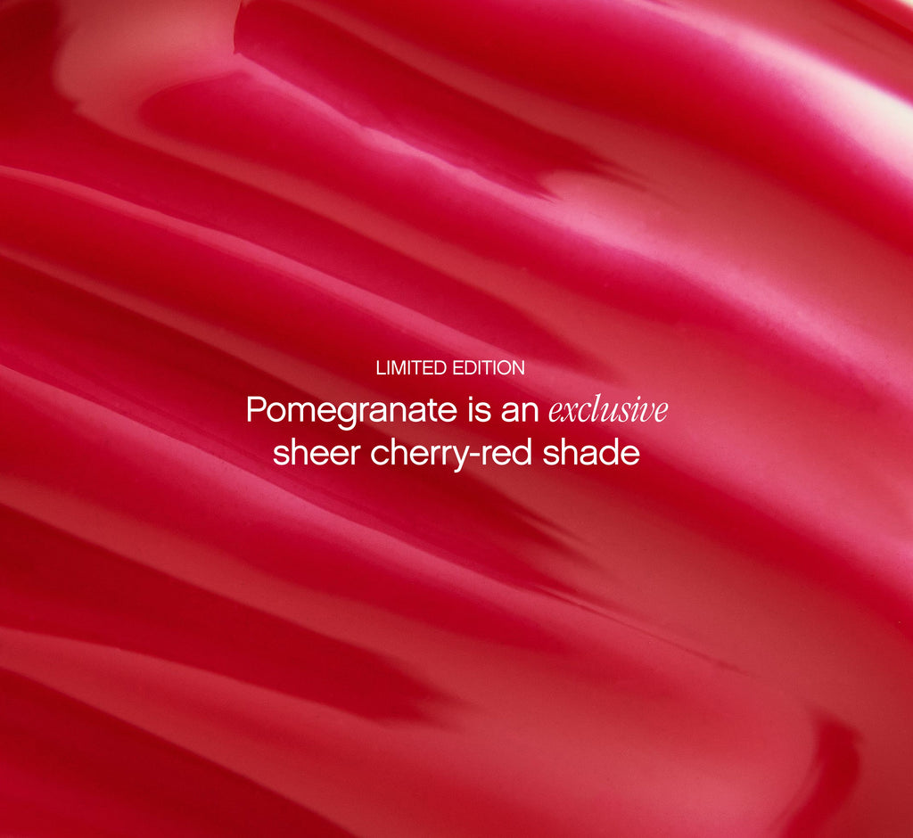 Moisturizing lip balm Pomegranate shade from Topicals Slick Salve shown as a close-up texture swatch of the limited-edition sheer cherry-red formula.