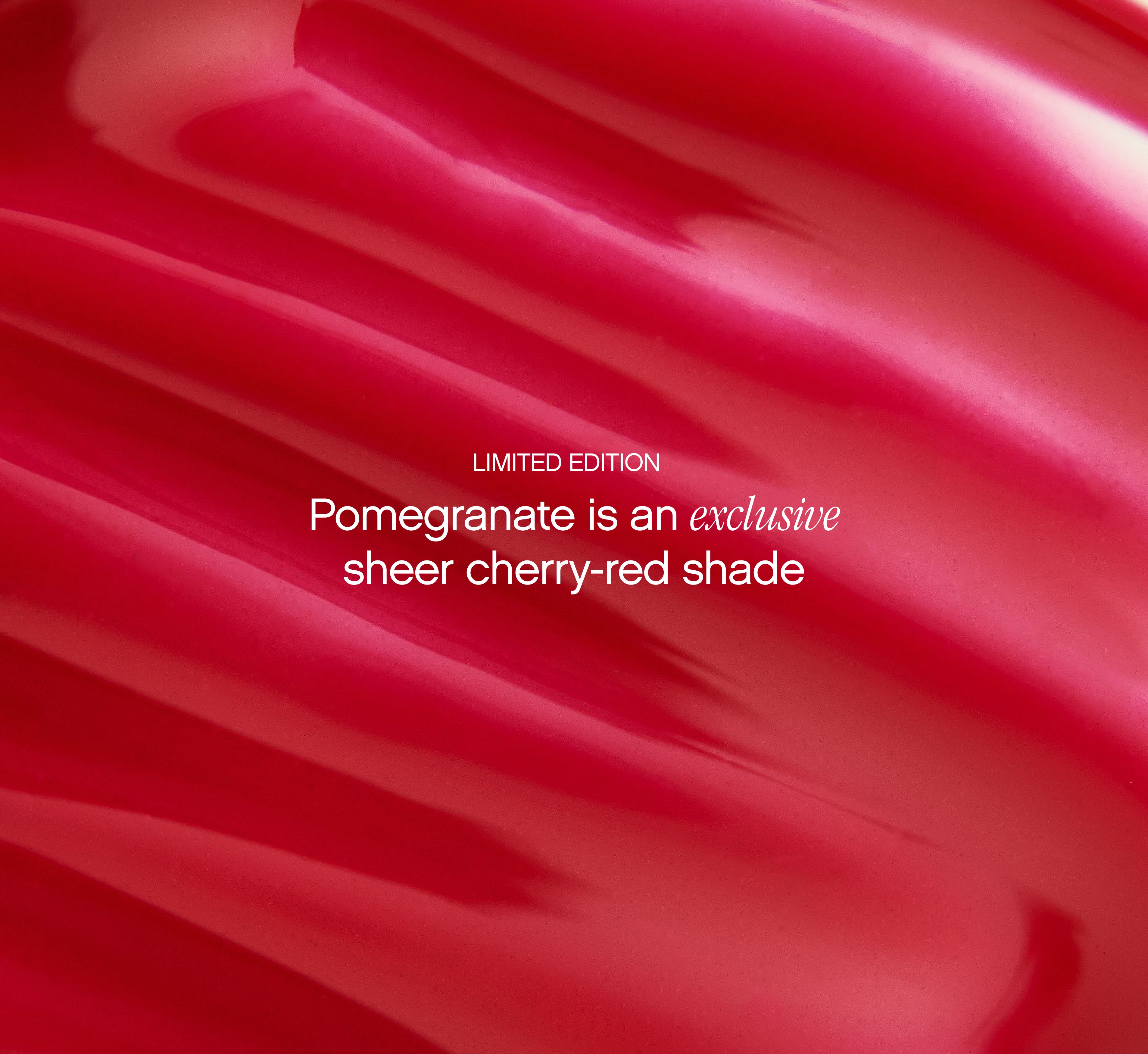 Moisturizing lip balm Pomegranate shade from Topicals Slick Salve shown as a close-up texture swatch of the limited-edition sheer cherry-red formula.