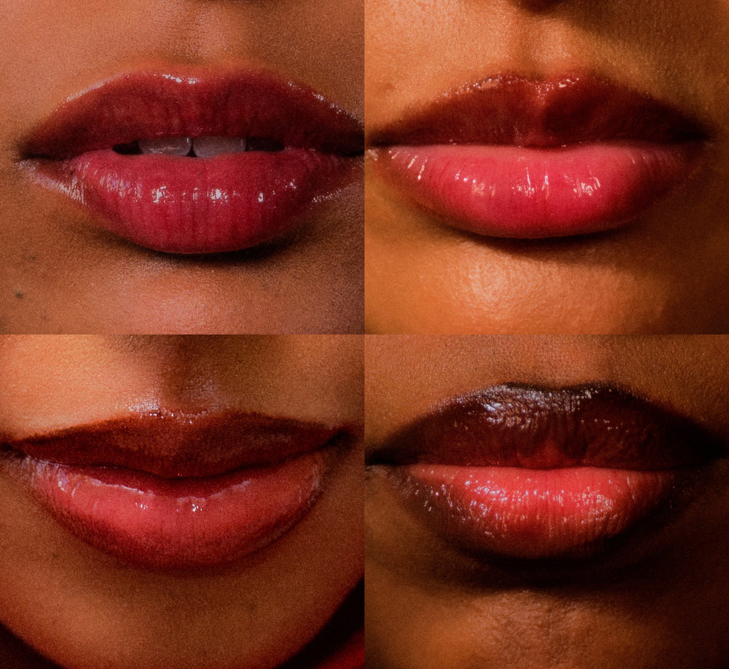 Moisturizing lip balm Pomegranate shade from Topicals Slick Salve shown swatched on four different skin tones ranging from medium to deep, displaying the sheer cherry-red finish.